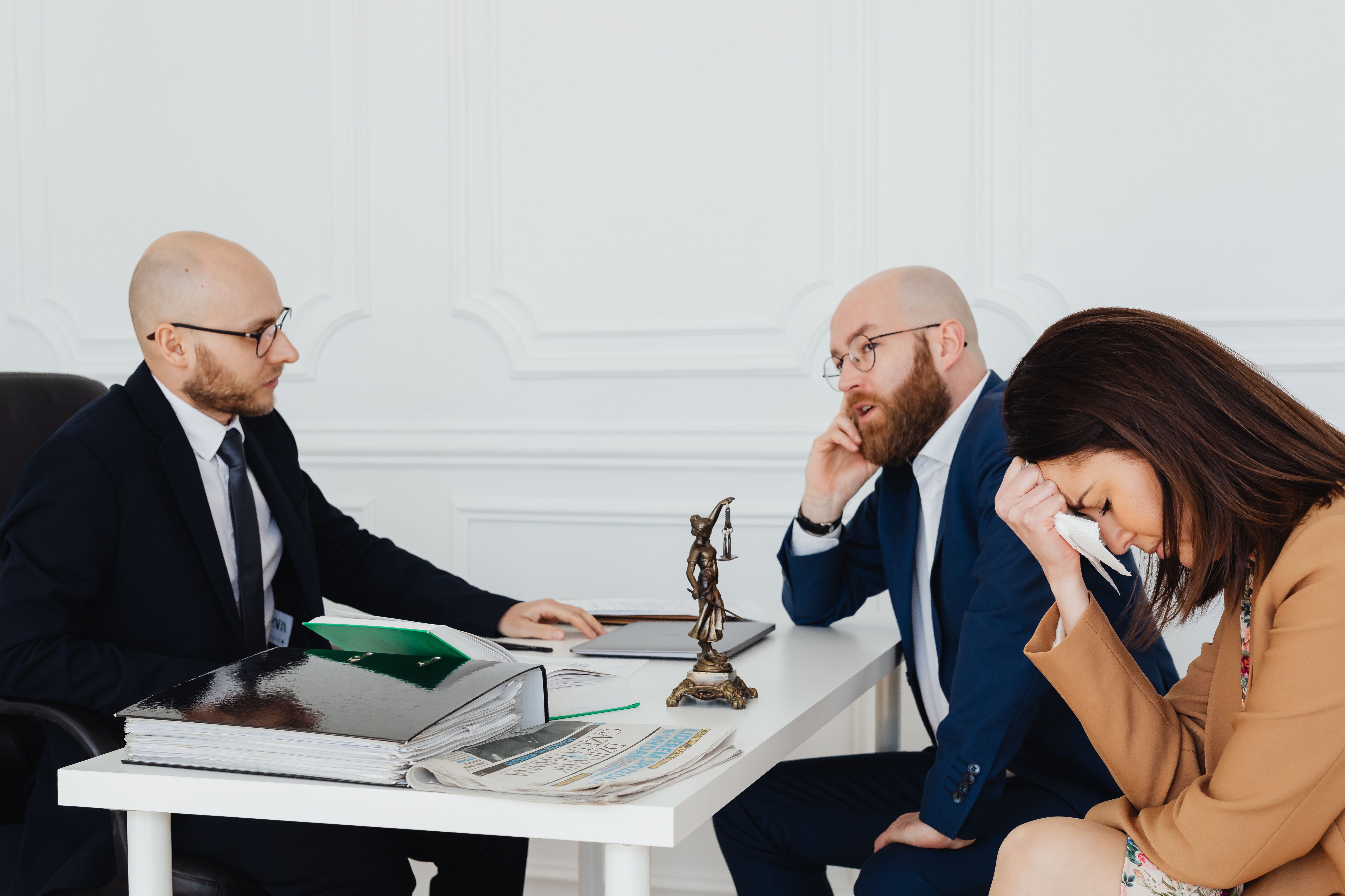 Legal team in a serious strategy discussion over documents during a complex litigation case